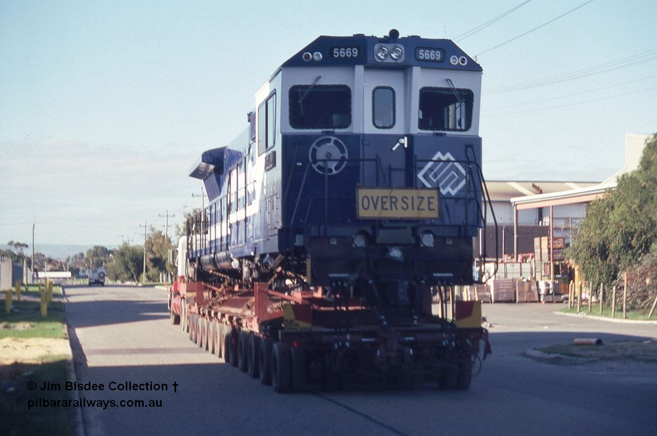 3585 001
Bassendean, Wood St, delivery of the final BHP CM40-8MEFI unit 5669 'Beilun' serial 8412-02 / 95-160. Unit was rebuilt as one of three with an electronic fuel injected prime mover by Goninan from Comeng built ALCo M636 unit 5486 serial C6084-2. Date July 1995.
Jim Bisdee photo.
Keywords: 5669;Goninan;GE;CM40-8EFI;8412-02/95-160;rebuild;Comeng-NSW;ALCo;M636C;5486;C6084-2;