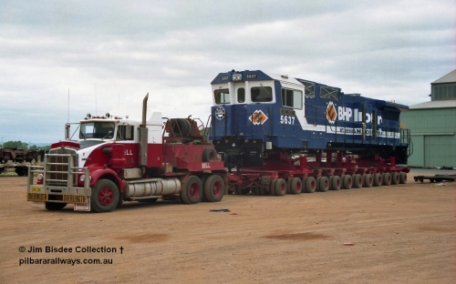 20845
Bassendean, Goninan workshops, newly completed BHP Iron Ore CM40-8M rebuild unit 5637 'De Grey' serial 8181-01 / 92-123 sits on a Bell road transport float with a Kenworth SAR bound for Port Hedland. 5637 was rebuilt from AE Goodwin ALCo C636 unit 5456 serial G6012-5. January 1992 image.
Jim Bisdee photo.
Keywords: 5637;Goninan;GE;CM40-8M;8181-01/92-123;rebuild;AE-Goodwin;ALCo;C636;5456;G6012-5;