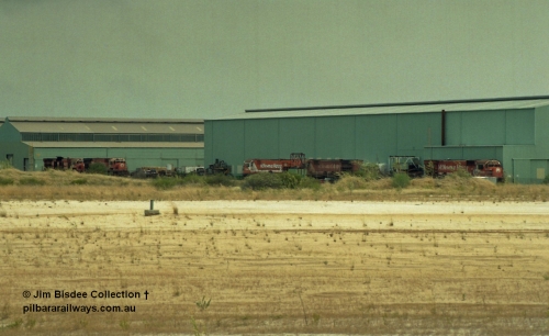 22928
Bassendean, Goninan workshops, view of several Mt Newman Mining ALCo units awaiting rebuilding or scrapping. November 1992.
Jim Bisdee photo.
