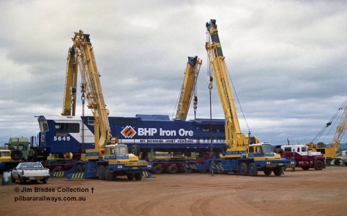 23885
Bassendean, Goninan workshops, BHP Iron Ore GE CM40-8M rebuild unit 5649 'Pohang' serial 8412-07 / 93-140 is lifted up with the Bell road transport float being prepped underneath for road haulage to Port Hedland. 5649 was rebuilt from AE Goodwin ALCo M636 unit 5473 serial G6047-5. July 1993.
Jim Bisdee photo.
Keywords: 5649;Goninan;GE;CM40-8M;8412-07/93-140;rebuild;AE-Goodwin;ALCo;M636C;5473;G6047-5;