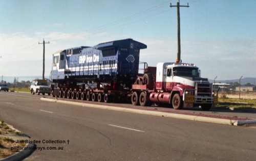 24134
Bassendean, Collier Road, Key Transport hauling the final BHP Iron Ore Goninan GE rebuilt CM40-8M unit 5669 serial 8412-02 / 95-160, which is actually an CM40-8MEFI as the final three had electronic fuel injection fitted to their 7FDL-16 engines. 5669 was rebuilt from Comeng NSW built ALCo M636 model 5486 serial C6084-2. July 1995.
Jim Bisdee photo.
Keywords: 5669;Goninan;GE;CM40-8EFI;8412-02/95-160;rebuild;Comeng-NSW;ALCo;M636C;5486;C6084-2;