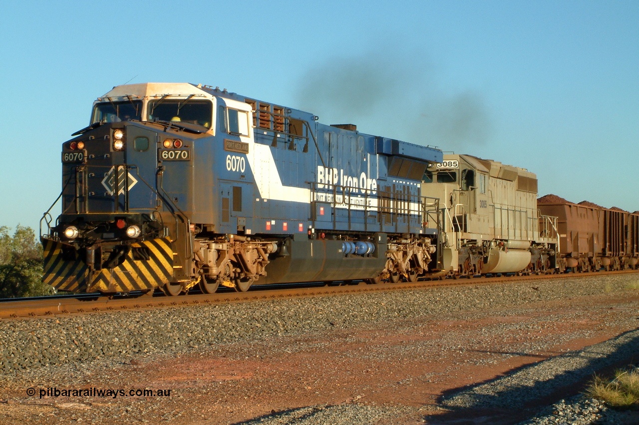 040507 170218r
Walla, BHP GE AC6000 locomotive class leader 6070 'Port Hedland' serial 51062 leads EMD built model SD40-2 unit 3085 serial 786170-25, former Union Pacific UP 3523, as they power up out of Walla siding having had an empty train cross pass, 7th May 2004.
Keywords: 6070;GE;AC6000;51062;