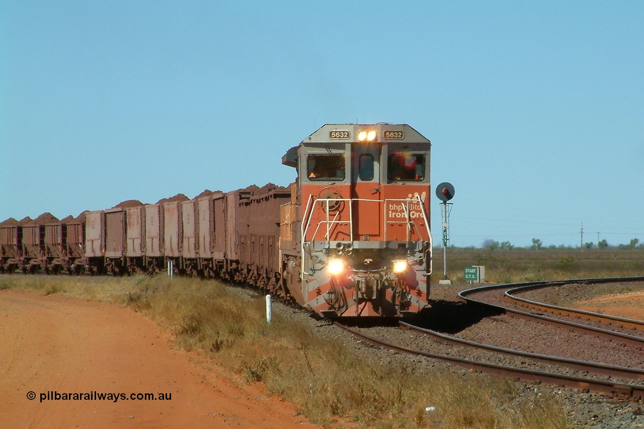040802 141058r
Goldsworthy Junction, BHP Billiton Goninan GE built CM39-8 5632 'Poseidon' serial 5831-11 / 88-081 in charge of the 'Recycle Rake' is traversing the Transfer Road, this train conveys ore from Nelson Point to Finucane Island, sometimes twice a day. The line to the right is the line to the Junction, Yarrie and Bing. 1410 hrs 2nd August 2004.
Keywords: 5632;Goninan;GE;CM39-8;5831-11/88-081;