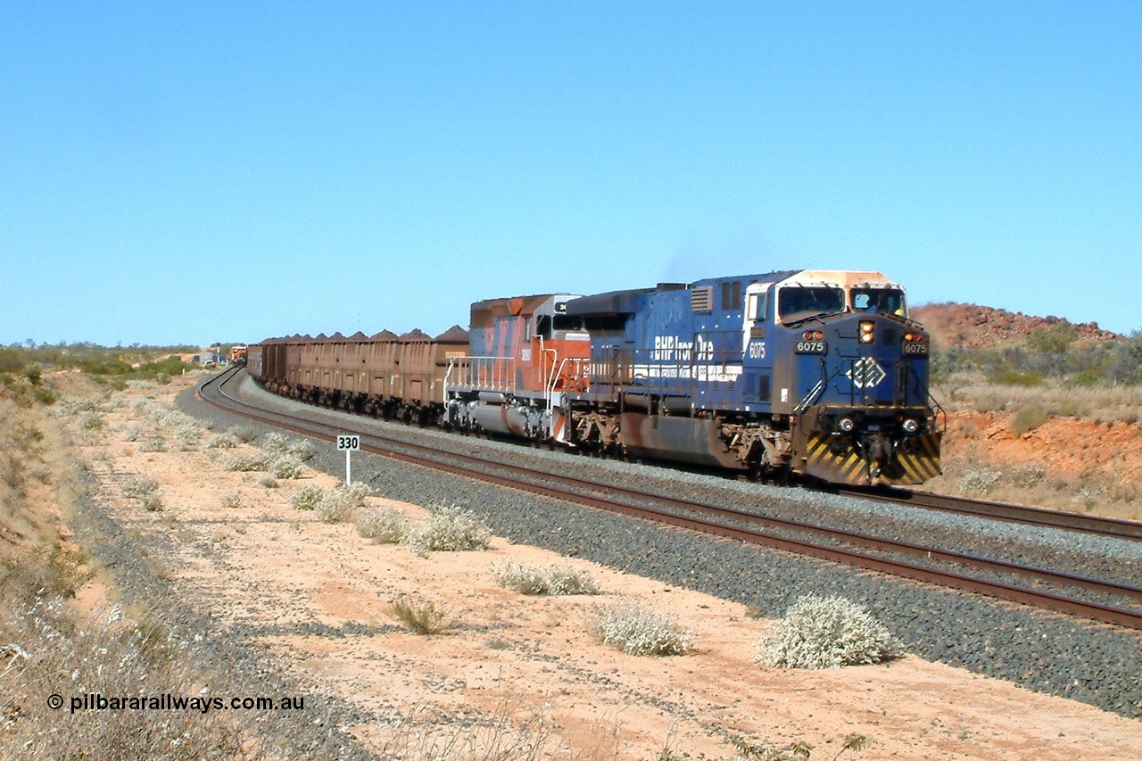 040810 101005r
Abydos Siding, BHP GE AC6000 6075 'Newman' serial 51067 leads EMD SD40R unit 3090 serial 33680 originally Southern Pacific SD40 SP 8488 on the mainline having passed Tamper 2. The 330 board is the 330 waggon train clearance point from the north end switch. 10th August 2004.
Keywords: 6075;GE;AC6000;51067;