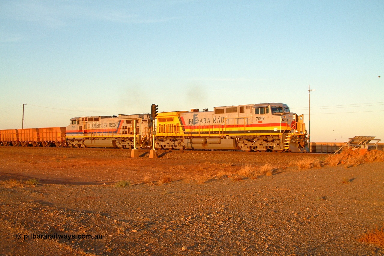 050108 184314r
Seven Mile yard departure with Hamersley Iron owned Pilbara Rail liveried General Electric built Dash 9-44CW unit 7097 'Ken Onley' serial 54160 and sister Hamersley Iron liveried 7093 serial 47772 power out of the yard an empty working in the late afternoon light at 1843 hrs Saturday 8th January 2005.
Keywords: 7097;GE;Dash-9-44CW;54160;