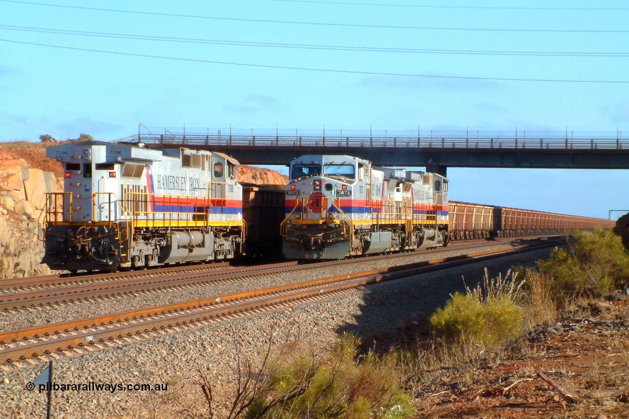 050110 072701r
Parker Point, brilliant summer morning light captures the driver in charge of General Electric built Dash 9-44CW units 7073 serial 47752 and 7078 serial 47757 stops to have a chat with the driver of the Parker Point dumper pilot on 7096 serial 52843 all wearing the original Hamersley Iron 'Pepsi' livery. Monday 10th January 2005.
Keywords: 7096;GE;Dash-9-44CW;52843;