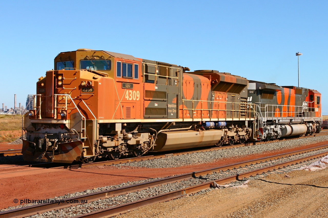 060710 6277r
Boodarie Yard, BHP Billiton Electro-Motive built SD70ACe/LC unit 4309 serial 20038540-010 and CM40-8M 5638 shunt through the yard during commissioning trials of Car Dumper 4 at Finucane Island. Boodarie Yard has just been expanded and the fence has since been put back up. 10th July 2006. Several years later both these locos and the HBI Plant in the background would all be gone!
Keywords: 4309;Electro-Motive;EMD;SD70ACe/LC;20038540-010;