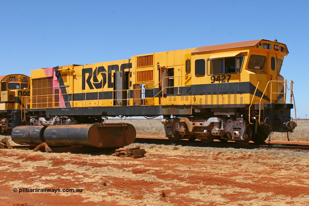 061209 8227r
Seven Mile 38 Road, retired Robe River Comeng WA ALCo rebuild model C636R unit 9427 serial WA143-2 sits stripped of engine, fuel tank and pilots ready for road haulage to Perth for rebuilding and use on FMG rail construction trains in May-June 2007. This unit was originally built by ALCo as C636 serial 3499-2 of January 1968 for Pennsylvania Railroad as #6331, and was purchased off Conrail as #6781 in 1986 and was rebuilt by Comeng WA prior to delivery in January 1987. 9th December 2006.
Keywords: 9427;Comeng-WA;C636R;WA143-2;rebuild;ALCo;Schenectady-NY;C636;Conrail;6781;3499-2;