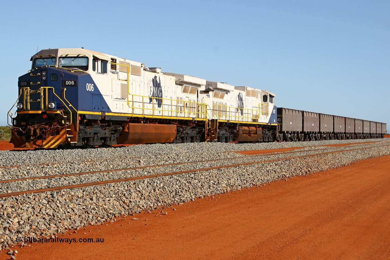 080120 1482r
Rowley Yard, FMG's General Electric built Dash 9-44CW DC locomotives 006 serial 58183 is coupled to 012 serial 58189 and five pairs of Chinese made ore waggons at the marshalling yard. These units were the last locomotives of this model built by General Electric. 20th January 2008.
Keywords: FMG-006;GE;Dash-9-44CW;58183;