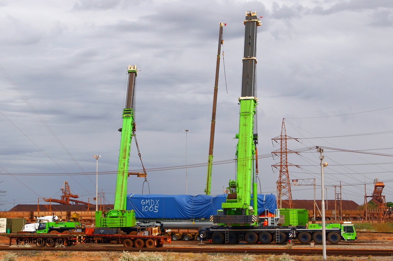 080612 2546
Nelson Point, the first BHP Billiton Electro-Motive built SD70ACe 'Pumpkin' unloaded off the heavy lift ship DA QIANG on Thursday 12th June 2008. The crane behind the loco is for removing the tarp the other two are a 300 tonne on the left an a massive 500 tonne on the right.
Keywords: GMDX1005;Electro-Motive;EMD;SD70ACe;