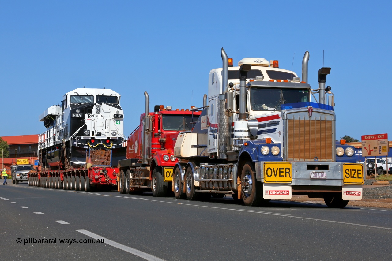 150130 7570
Port Hedland, Wilson Street, now with the second ALE Kenworth prime mover coupled up Roy Hill's General Electric built ES44ACi unit RHA 1011 serial 62583 heads off to be placed on rails. 30th January 2015.
Keywords: RHA-class;RHA1011;GE;ES44ACi;62583;