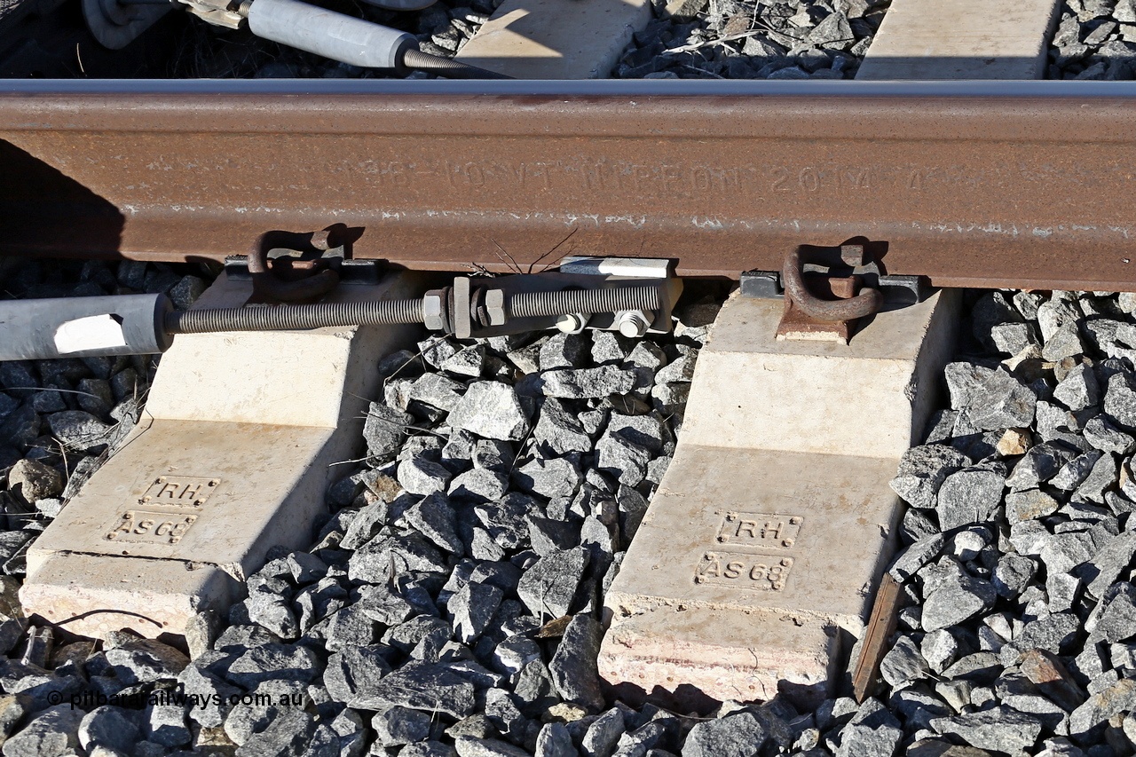 180701 9485r
Roy Hill track formation near the 63 km. Sleepers are moulded RH for Roy Hill and AS68 as manufactured to suit AS68 rail profile. The rail is moulded 136 10 VT NIPPON 2014 4 which translates to 136 Ib/yard (or 68 kg/m), 10 for Low Alloy, VT for processes of hydrogen elimination as Vacuum Treated, NIPPON is the manufacturer Nippon Steel, Japan, 2014 year rolled and 4 is month rolled.

