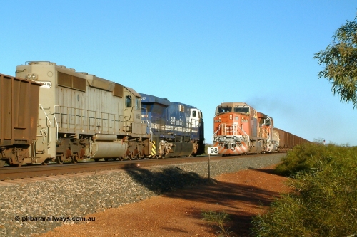 040810 165626r
Gillam Siding BHP Billiton GE AC6000 6076 'Mt Goldsworthy' serial 51068 leads an all bubble paint quin consist on the main with EMD SD40R 3091 serial 31496 originally Southern Pacific SD40 SP 8415 and mid-train units CM40-8M 5636 leading newly delivered SD40R units 3095 and 3096 as they cross an empty headed up by GE AC6000 6077 'Nimingarra' serial 51069 and EMD SD40-2 3085 serial 786170-25 and originally Union Pacific UP 3523. 10th August 2004.
Keywords: 6076;GE;AC6000CW;51068;