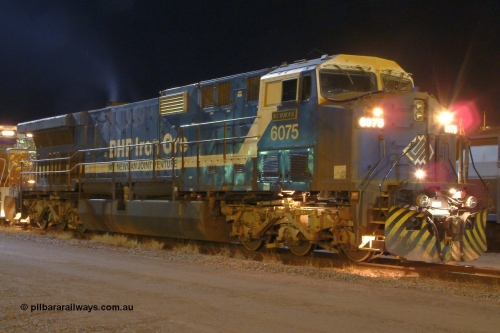 040819 042026r
Nelson Point yard, BHP GE AC6000 6075 'Newman' serial 51067 waits in the early hours of 19th August 2004 with a loaded rake for entry into Car Dumper 3 and the dumping of its train.
Keywords: 6075;GE;AC6000CW;51067;