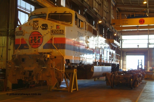 050109 181900r
Seven Mile, Hamersley Iron General Electric built Dash 9-44CW unit 7094 serial 52841 sits in the shed partially stripped for accident repairs. Note the knuckle has been pushed right back into the draft pack as a result of the impact. Sunday 9th January 2005.
Keywords: 7094;GE;Dash-9-44CW;52841;