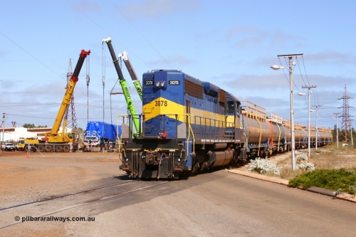 051023 6215r
Nelson Point, BHP Billiton EMD built SD40 unit 3078 built February 1966 serial 31503 / 7861-13 still in previous owner IC & E blue and yellow runs out of the fuel gantry with loaded tank waggons as Electro-Motive (EMD successor) built SD70ACe/LC unit 4305 is lowered onto the rails. 23rd October 2005.
Keywords: 3078;EMD;SD40;31503/7861-13;SP8422;