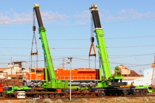 080614 2605
Nelson Point hard stand sees BHP Billiton's latest Electro-Motive SD70ACe unit 4331 serial 20066862-060 originally built for BNSF as BNSF 9189 in all over BNSF orange referred to as 'pumpkins'. A 300 tonne crane on the left and an even bigger 500 tonne crane combine to lift the 200 tonne mass of the 4300 hp SD70ACe locomotive, 14th June 2008.
Keywords: 4331;Electro-Motive-London-Ontario;EMD;SD70ACe;20066862-060;BNSF-9189;