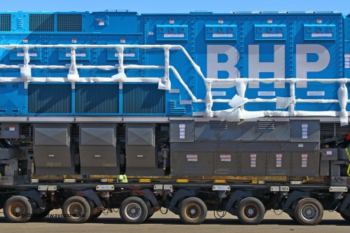 w r251114 4370
BHP's Battery Electric Locomotive 9001 class leader, a brand new Wabtec built FLXdrive ™ battery electric locomotive, or BEL, sits in the Gobi hard stand area of Pilbara Ports Authority as it awaits delivery to site.
The BEL's, 9001 and 9002 were built by Wabtec at their Erie, Pennsylvania, USA plant and are designated as model FXH70C. Both locos were shipped on the BBC St Petersburg and road transport is provided by Tutt Bryant.
9001 has serial number 66453 and a built date of Dec 2023.
November 14, 2025.
Keywords: 9001;66453;Wabtec;BEL;FXH70C;