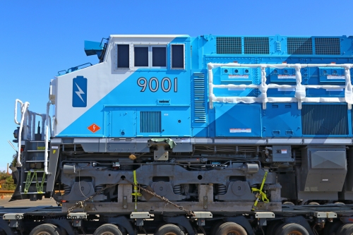 w r251114 4384
BHP's Battery Electric Locomotive 9001 class leader, a brand new Wabtec built FLXdrive ™ battery electric locomotive, or BEL, sits in the Gobi hard stand area of Pilbara Ports Authority as it awaits delivery to site.
The BEL's, 9001 and 9002 were built by Wabtec at their Erie, Pennsylvania, USA plant and are designated as model FXH70C. Both locos were shipped on the BBC St Petersburg and road transport is provided by Tutt Bryant.
9001 has serial number 66453 and a built date of Dec 2023.
November 14, 2025.
Keywords: 9001;66453;Wabtec;BEL;FXH70C;