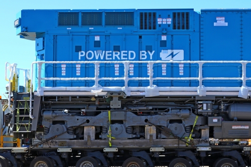 w r251114 4406
BHP's Battery Electric Locomotive 9002, a brand new Wabtec built FLXdrive ™ battery electric locomotive, or BEL, sits in the Gobi hard stand area of Pilbara Ports Authority as it awaits delivery to site.
The BEL's, 9001 and 9002 were built by Wabtec at their Erie, Pennsylvania, USA plant and are designated as model FXH70C. Both locos were shipped on the BBC St Petersburg and road transport is provided by Tutt Bryant.
9002 has serial number 66454 and a built date of Dec 2023.
November 14, 2025.
Keywords: 9002;66454;Wabtec;BEL;FXH70C;